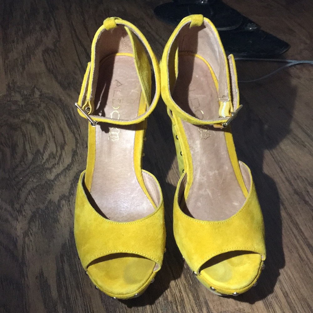 Yellow ALDO studded wedges.